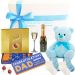 Celebration gift for new father with champagne and baby boy keepsakes