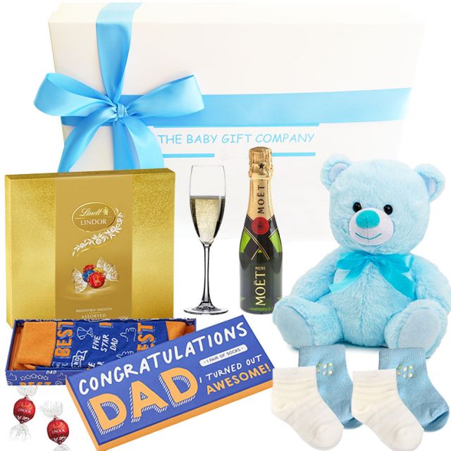 Celebration gift for new father with champagne and baby boy keepsakes